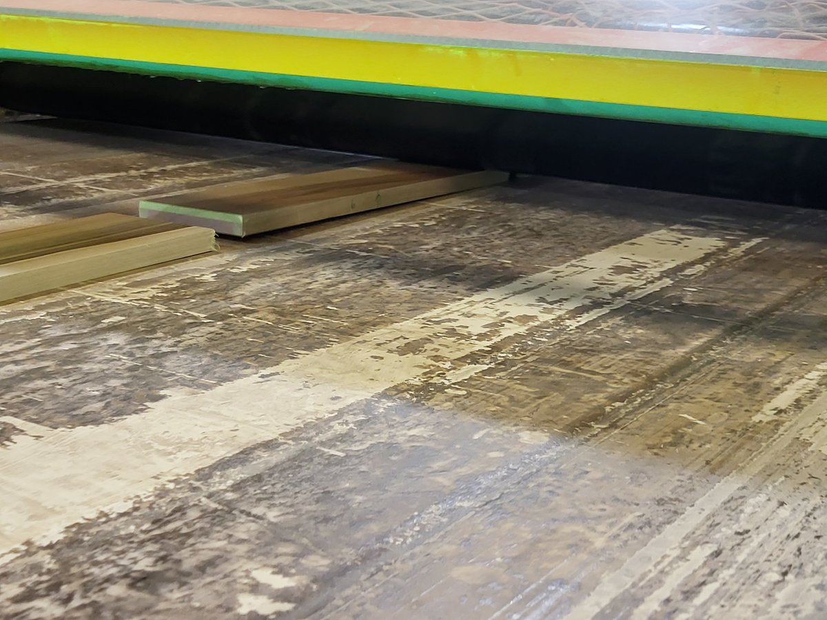 Wood plank going through planer